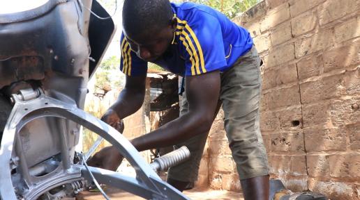 Lamin Saidy, a renowned auto-mechanic in his neighborhood is inspired by the deep desire to ensure his younger siblings live a better life